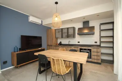 a kitchen with a table and chairs and a television at Al Covo dei Mori in Bagheria