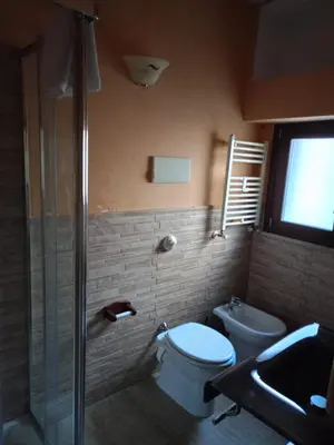 a bathroom with a toilet and a shower and a sink at LE CAMERE AL CASSARO in Palermo