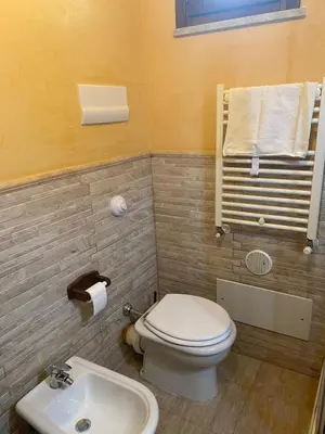 a bathroom with a toilet and a sink at LE CAMERE AL CASSARO in Palermo