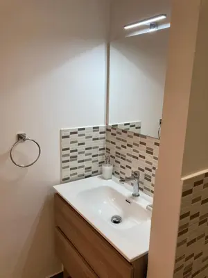 a bathroom with a sink and a mirror at Teatro Apartments Giardino Inglese in Palermo