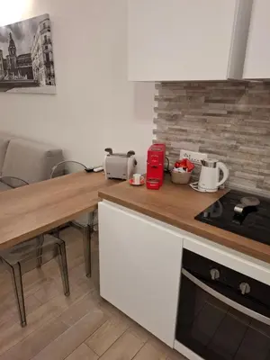 a kitchen with a wooden counter top with a stove at Teatro Apartments Giardino Inglese in Palermo