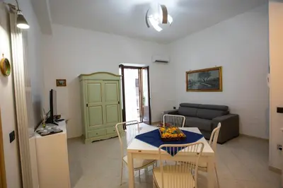 a living room with a table and chairs and a couch at Sol&Luna 1909 Tourist Location in Old Town in Palermo