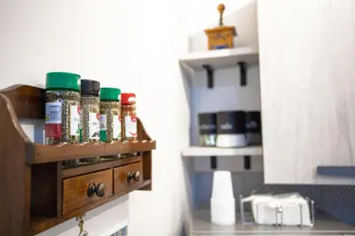 a spice rack on the wall of a kitchen at Sol&Luna 1909 Tourist Location in Old Town in Palermo