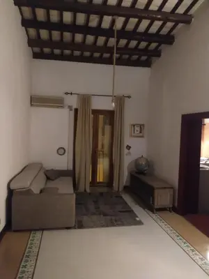 a living room with a couch and a table at Fra la città storica e quella ottocentesca in Palermo