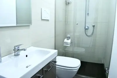 a bathroom with a toilet and a sink and a shower at Due Cani in Palermo