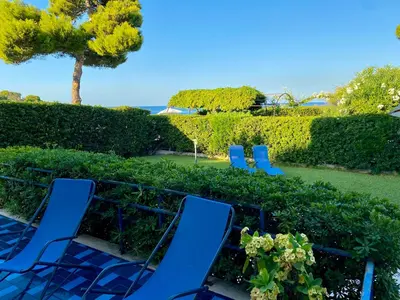 two blue lawn chairs sitting in a hedge at Luxury Villa just 50 mt from the beach, 10 minutes from the airport in Carini