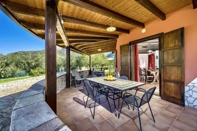 an outdoor dining area with a table and chairs at Villa Giuliana in Castellammare del Golfo
