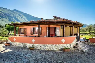 a small house with a stone wall at Villa Giuliana in Castellammare del Golfo