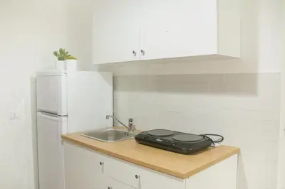 a kitchen counter with a sink and a refrigerator at Vicolo del Salto in Palermo