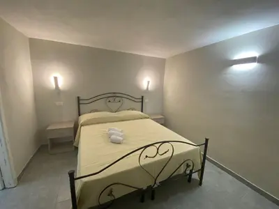 a bedroom with a bed with two towels on it at Case Vacanze Seggettieri in Palermo