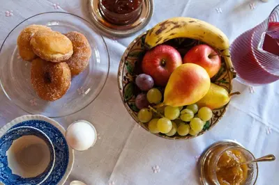 a table with a bowl of fruit and a bowl of eggs at Il Glicine sul Golfo in Mondello