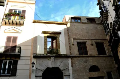 a building in the middle of a street at Home Resuttano in Palermo