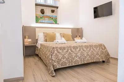 a bedroom with a bed with two pillows on it at Barlaman Luxury Rooms in Palermo
