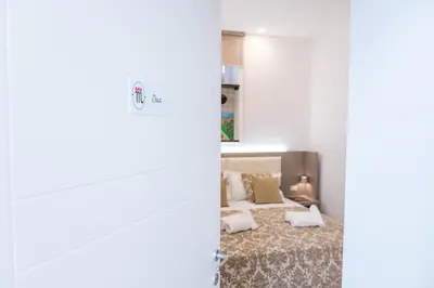 a bedroom with a bed and a mirror at Barlaman Luxury Rooms in Palermo