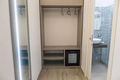 a bathroom with a walk in closet with a sink at Barlaman Luxury Rooms in Palermo