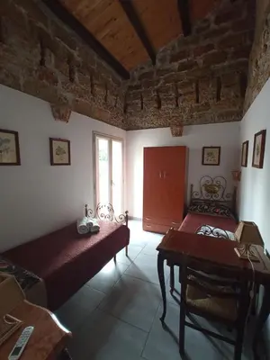 a room with two beds and a table in it at ZyZ Apartments La Kalsa in Palermo