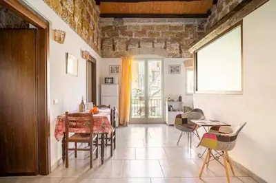 a dining room with a table and chairs at ZyZ Apartments La Kalsa in Palermo
