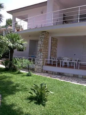 a house with a patio and a table on the balcony at Scopello sul mare 1 in Castellammare del Golfo