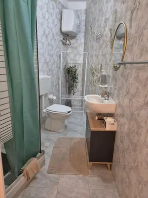 a bathroom with a toilet and a sink and a shower at La casuzza 1 in Palermo