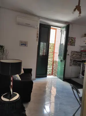 a living room with a couch and a table at La casuzza 1 in Palermo