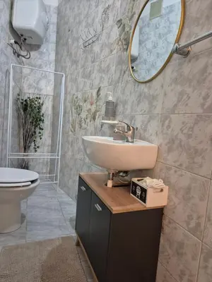 a bathroom with a sink and a toilet and a mirror at La casuzza 1 in Palermo