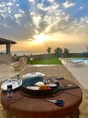 a table with a plate of food on a table at Villa Romitello con Piscina Total Relax in Borgetto