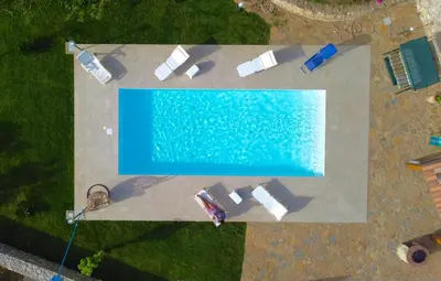an overhead view of a swimming pool with towels and a swimming at Villa Romitello con Piscina Total Relax in Borgetto