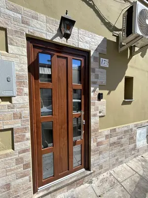 a wooden door on the side of a building at Dimora Palermo with private pool in Palermo