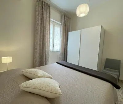 a bedroom with a bed with two pillows on it at Casa Magione in Palermo