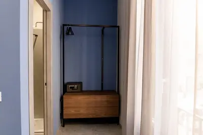 a room with a mirror and a dresser with a clock at Granatelli Rooms in Palermo