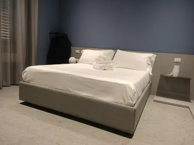 a bed with two stuffed animals sitting on top of it at Granatelli Rooms in Palermo