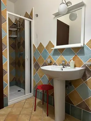 a bathroom with a sink and a mirror and a shower at CASE COLOMBO E MATTARELLA by Trerose Properties - Appartamenti centrali con wi-fi e posto auto privato gratuito in San Vito lo Capo