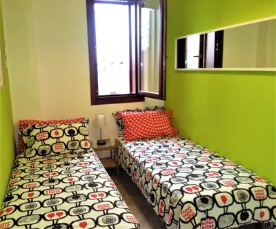 a small room with two beds and a window at CASE COLOMBO E MATTARELLA by Trerose Properties - Appartamenti centrali con wi-fi e posto auto privato gratuito in San Vito lo Capo