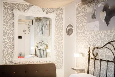 a bedroom with a mirror and a bed at Casale D' Or in Palermo