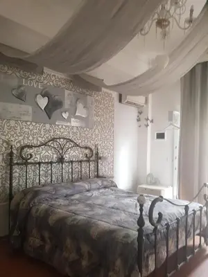a bedroom with a large bed with hearts on the wall at Casale D' Or in Palermo