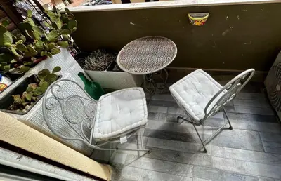 a patio with a table and two chairs and a table and a table and chairs at Casale D' Or in Palermo