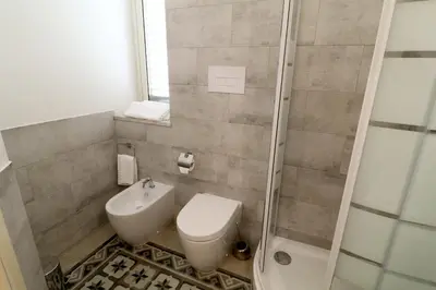a bathroom with a sink and a toilet and a shower at Le stanze di Bianca in Palermo