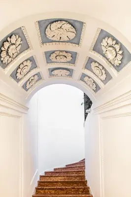 an archway with paintings on the ceilings in a building at Moncada Suites & Apartments in Palermo