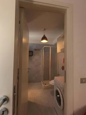 a bathroom with a shower and a toilet and a sink at casa magoo in Palermo
