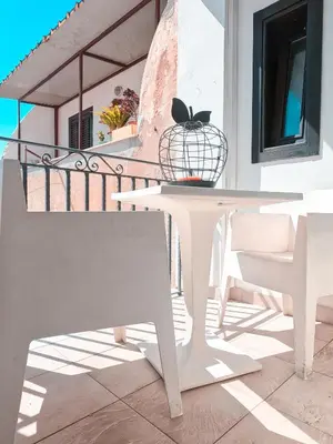 a white table and chairs on a balcony at casa magoo in Palermo