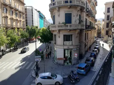 a building on a city street with cars parked in front at Ai Giudici in Palermo