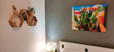 a bedroom with a bed and a painting on the wall at Ai Giudici in Palermo