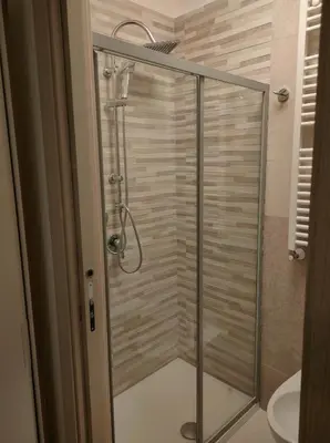 a shower with a glass door in a bathroom at Ai Giudici in Palermo