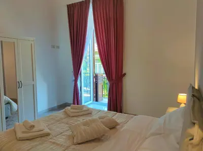 a bedroom with a bed with towels on it at Ai Giudici in Palermo