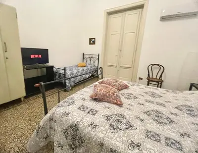 a bedroom with a bed and a tv in it at Suite Dreams Politeama in Palermo