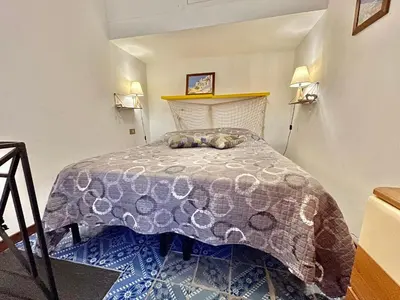 a bedroom with a bed with a purple comforter at Suite Dreams Politeama in Palermo