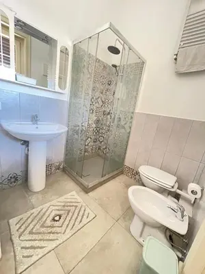 a bathroom with a shower and a toilet and a sink at Suite Dreams Politeama in Palermo