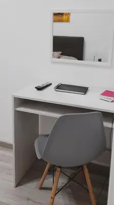 a white desk with a chair and a laptop at Rosina's flat in Palermo