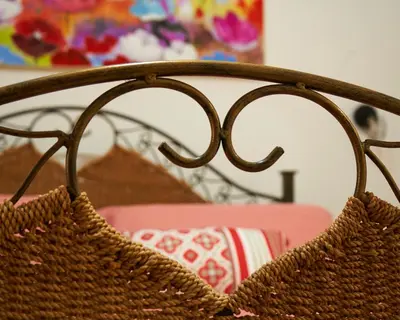 a rattan purse hanging on the back of a chair at Ballarò Guest House in Palermo
