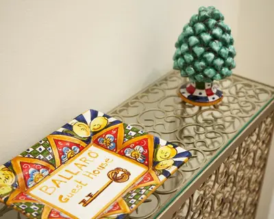 a table with a key and a christmas tree on it at Ballarò Guest House in Palermo